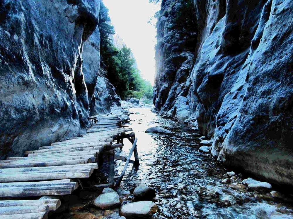 Samaria Gorge in Crete, Greece – hikers walking through the dramatic canyon in the White Mountains